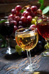 assortment different wine on dark wooden table, vertical
