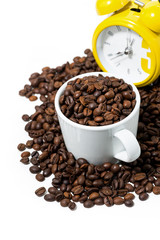 cup with coffee beans and yellow alarm clock on white background, vertical