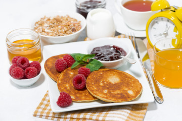 delicious pancakes with fresh raspberries and jam for breakfast