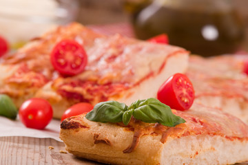 Italian pizza with cheese, tomatoes and fresh basil. 