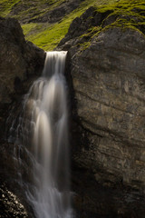 water fall of Altein near Arosa in summer with green meadow