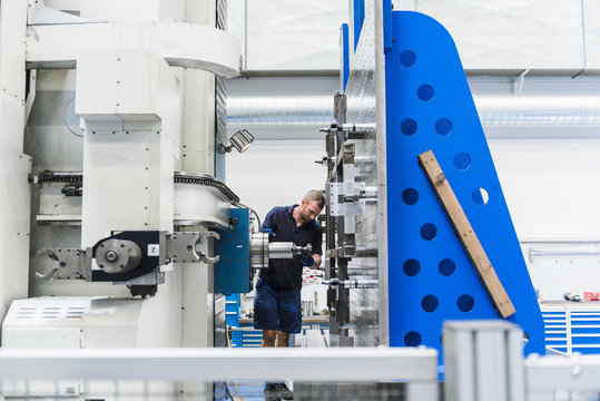 Man working on machine in industrial factory