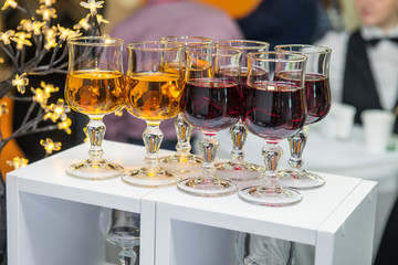 Catering table with alcoholic and non-alcoholic drinks on the business event in the hotel hall. Service at business meeting, party, weddings. Selective focus, space for text.