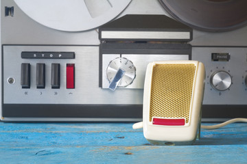 vintage microphone and reel to reel tape recorder