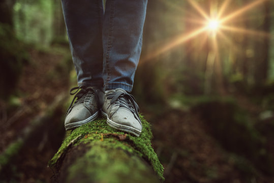 Woman Walking On A Log In The Forest