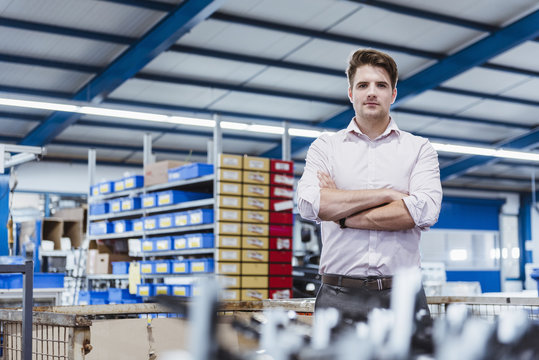 Employee Standing In Shop Floor With Arms Crossed, Portrait