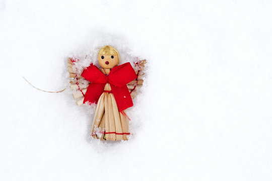 Angel toy on snow background