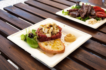 Delicious steak tartare raw beef on white plate.