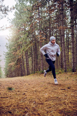 Fast runner exercising outside in the mountain. Sport in extreme conditions.