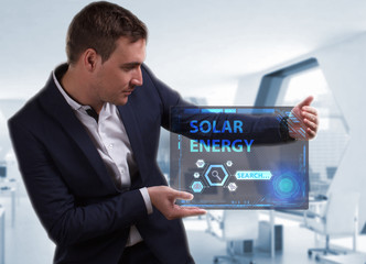 Business, Technology, Internet and network concept. Young businessman working on a virtual screen of the future and sees the inscription: Solar energy