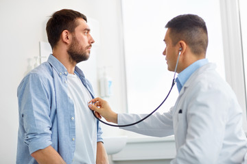 doctor with stethoscope and patient at hospital