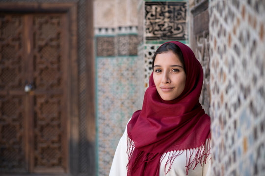 Arab woman in traditional clothing with red hijab
