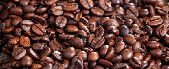 Roasted coffee beans background. Closeup view and details.