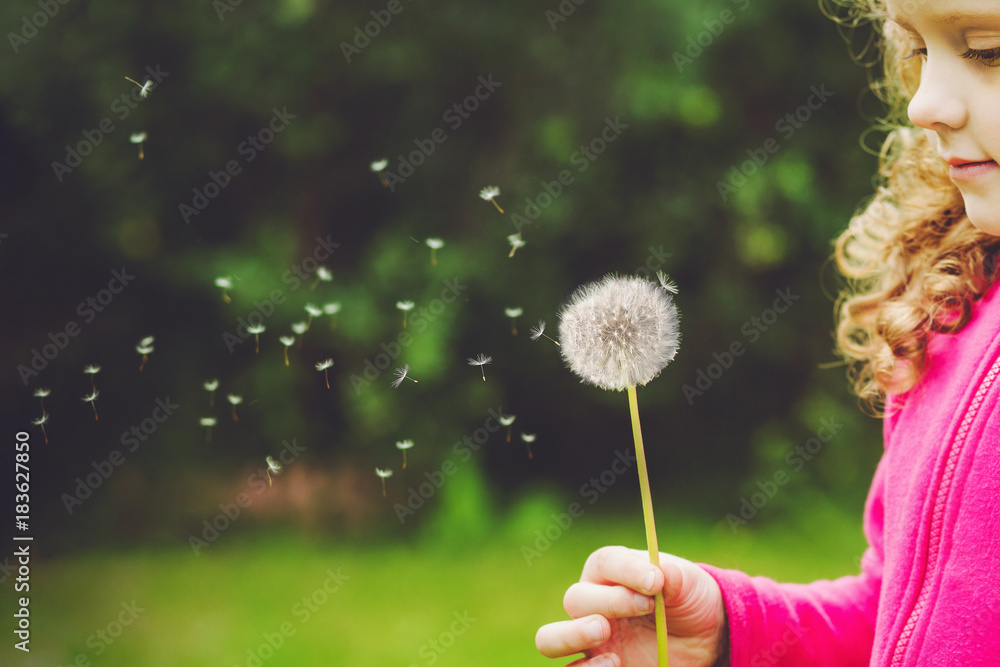 Sticker little curly girl blowing dandelion