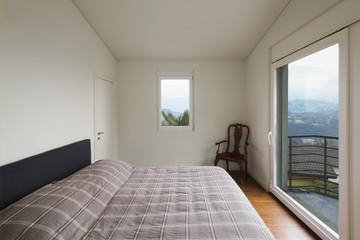 White bedroom, large windows