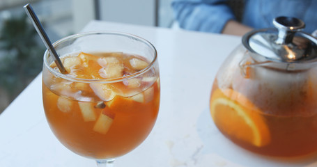 Woman drink iced fruit tea in restaurant