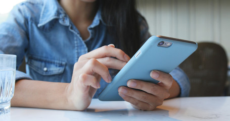 Woman use of smart phone in restaurant