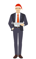 Businessman in Santa hat holding digital tablet PC