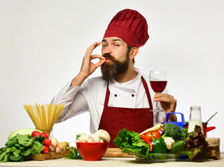 Chef prepares meal. Man with beard shows Perfect Taste sign