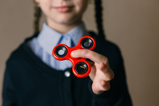 Little girl playing with a spinner