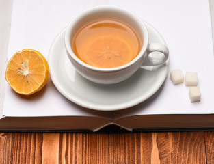 Cup of green tea with slice of lemon.