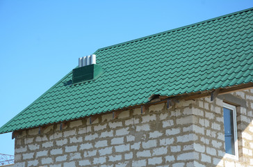 Close up on Damaged house metal roof sheets after hurricane  to repair roof.