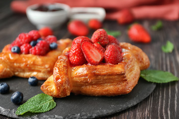 Yummy puff pastry with berries on slate plate