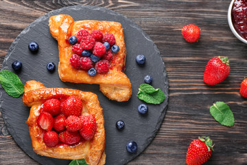 Yummy puff pastry with berries on slate plate