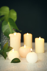 Obraz na płótnie Canvas Burning candles on table against dark background