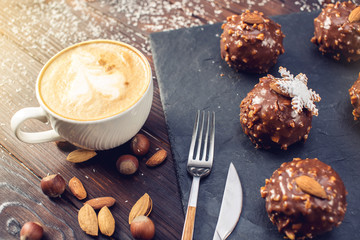 Homemade Christmas or New Year holiday chocolate brownies with nuts on wooden background. Concept of festive desserts