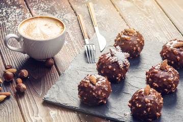 Homemade Christmas or New Year holiday chocolate brownies with nuts on wooden background. Concept of festive desserts