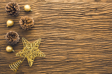 Fototapeta na wymiar gold star glitter decor with wood pine cone in christmas concept with flat lay top view
