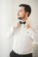 Beautiful man, groom posing and preparing for wedding