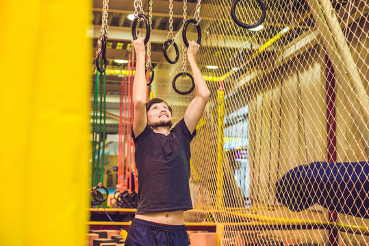 The Man Passes The Obstacle Course In The Sports Club