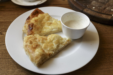 Hot tortilla with cheese and bechamel sauce. Khachapuri, Caucasian kitchen. Restaurant Shot.