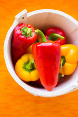 yellow and red peppers closeup on orange napkin.