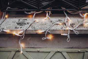 christmas lights decoration on window  in snowy city streets. european city preparing for winter christmas holidays, space for text. beautiful outdoor illumination