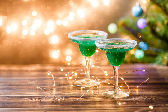 Christmas photo of two wine glasses with green cocktail