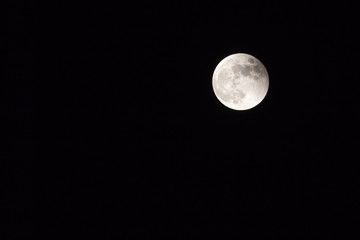 full moon in a dark night sky horizontal with copy space