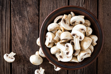 Fresh mushrooms on wooden table, top view