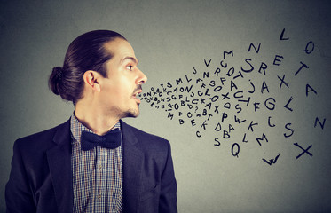 Man talking with alphabet letters coming out of his mouth. Communication, information, intelligence concept - obrazy, fototapety, plakaty