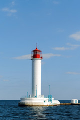 Fototapeta na wymiar Lighthouse in the afternoon in a calm sea