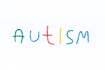 Childhood diseases. Word autism on white background top view copyspace