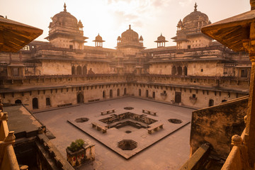 Orchha Palace, interior with courtyard and stone carvings, backlight. Also spelled Orcha, famous travel destination in Madhya Pradesh, India.