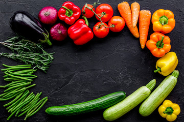 Colorful vegetables for healthy diet. Paprika, tomatoes, carrot, zucchini, eggplant on balck background top view copyspace