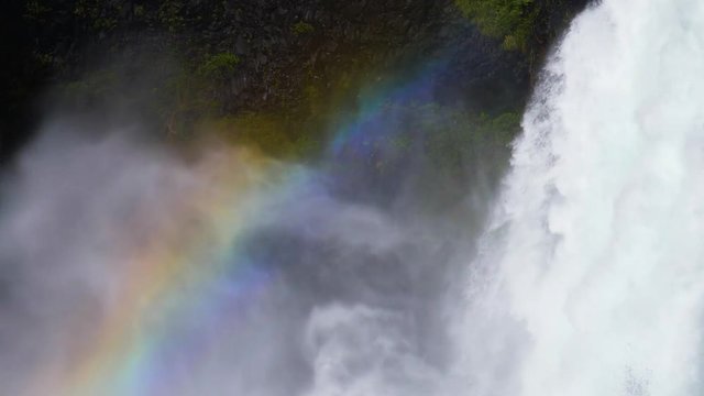 Rainbow in a huge waterfall in Chilean scenery Huilo Huilo