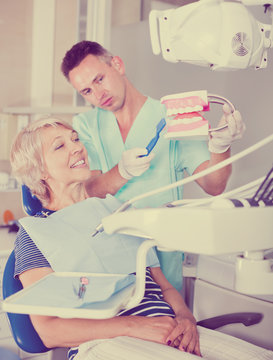 Dentist explaining future treatment to female patient
