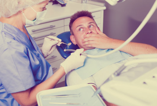 Frightened guy in dental chair