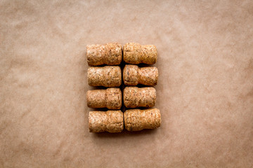 Wine bottle corks pattern on craft paper background top view copyspace. New Year celebration concept