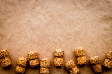 Wine bottle corks pattern on craft paper background top view copyspace. New Year celebration concept